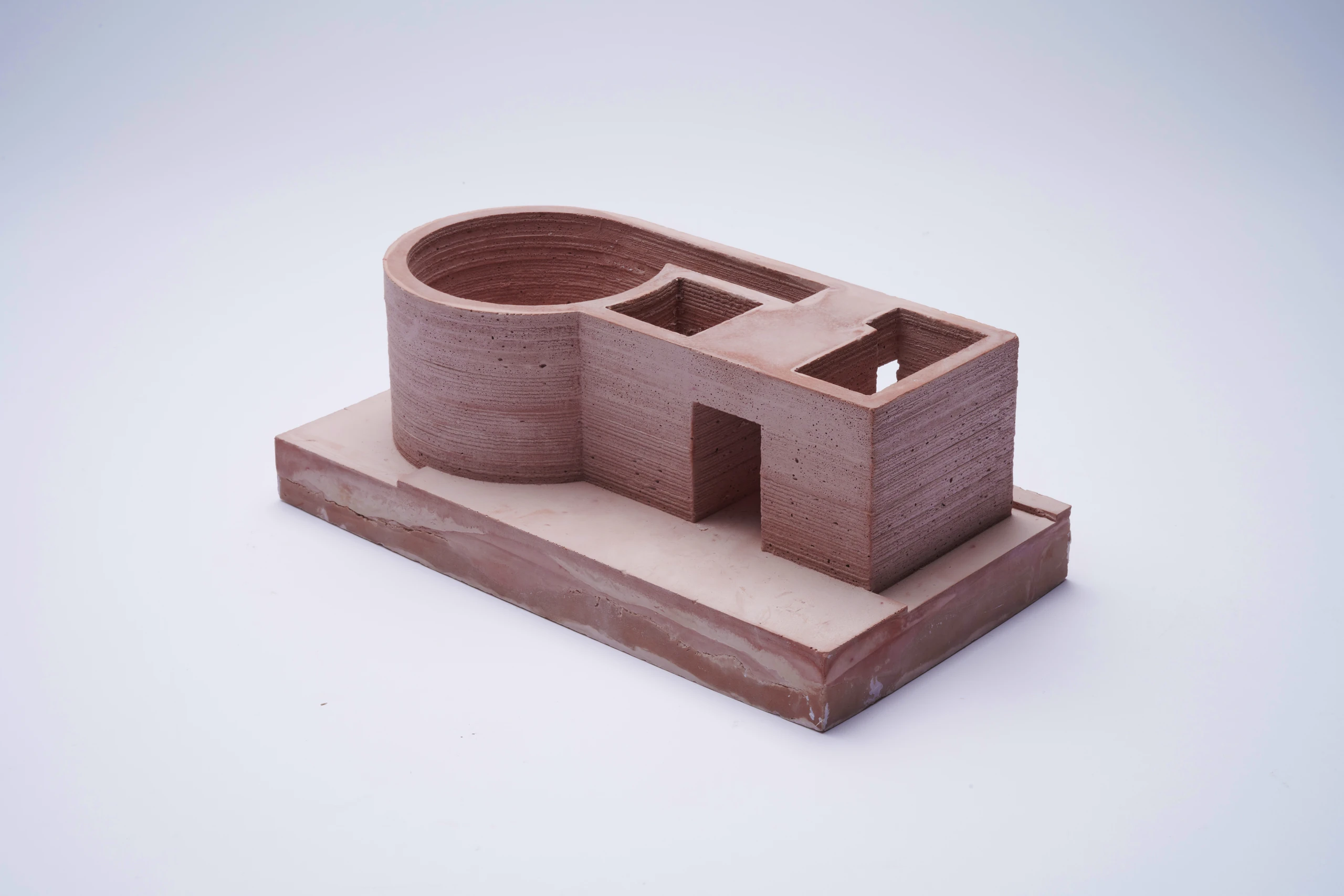 Pigmented plaster model with a cylindrical pool and adjoining rooms