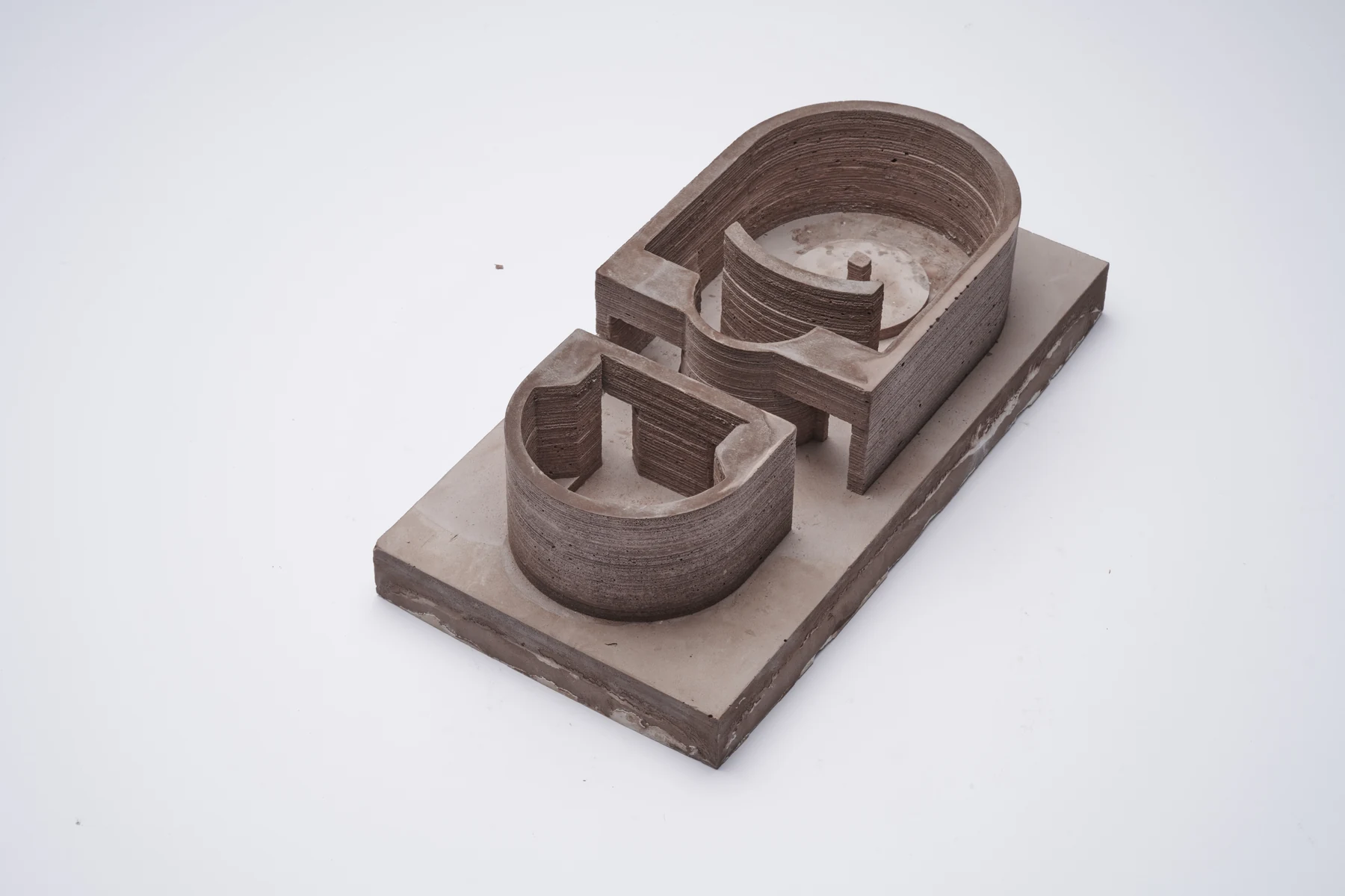 Model of two curved bathing pools set on a concrete base