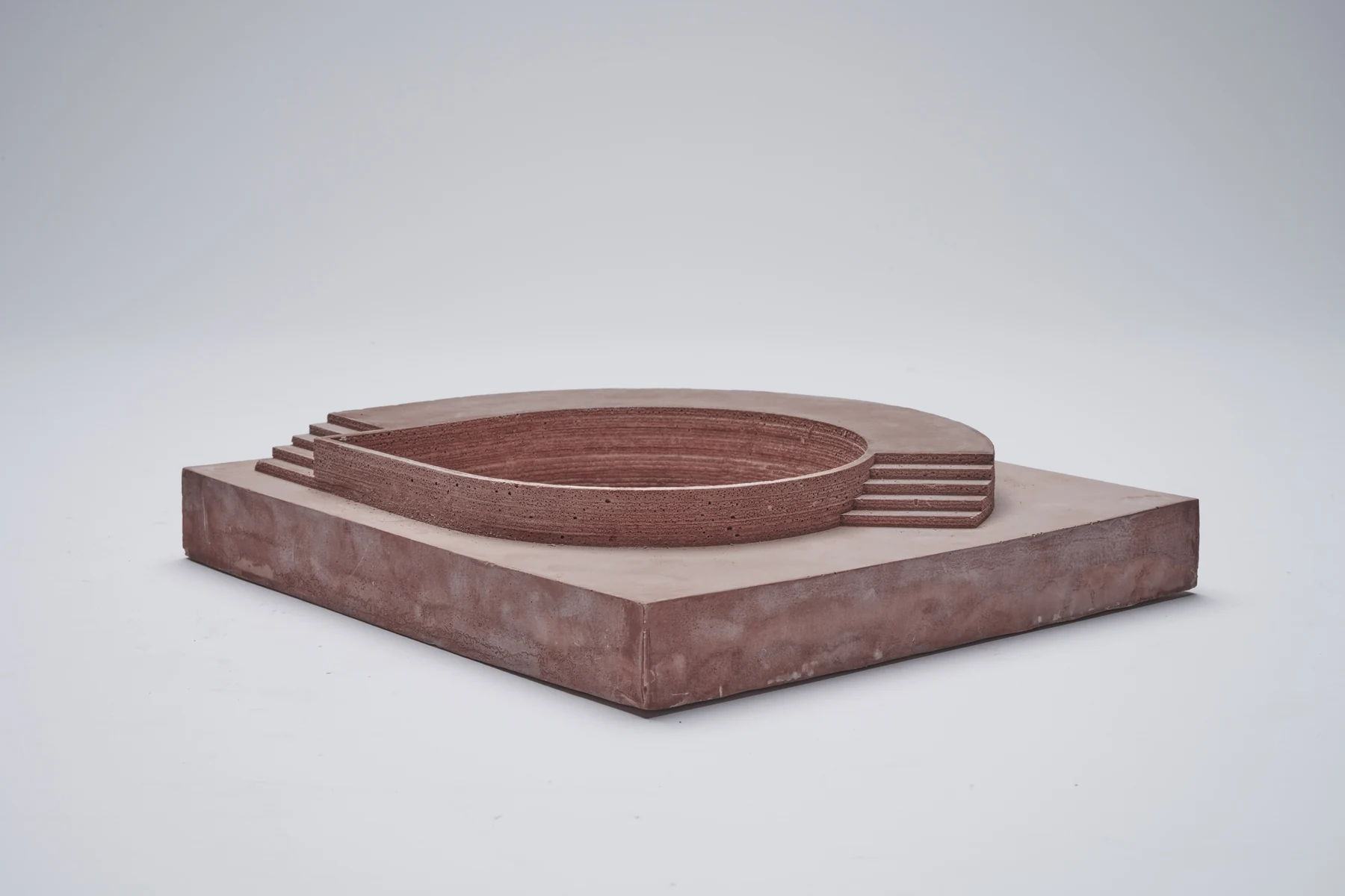 Model of an oval basin with stepped terraces on a red plaster base