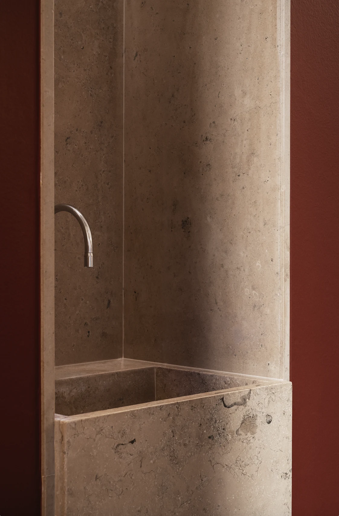 Stone basin with a slender brass tap