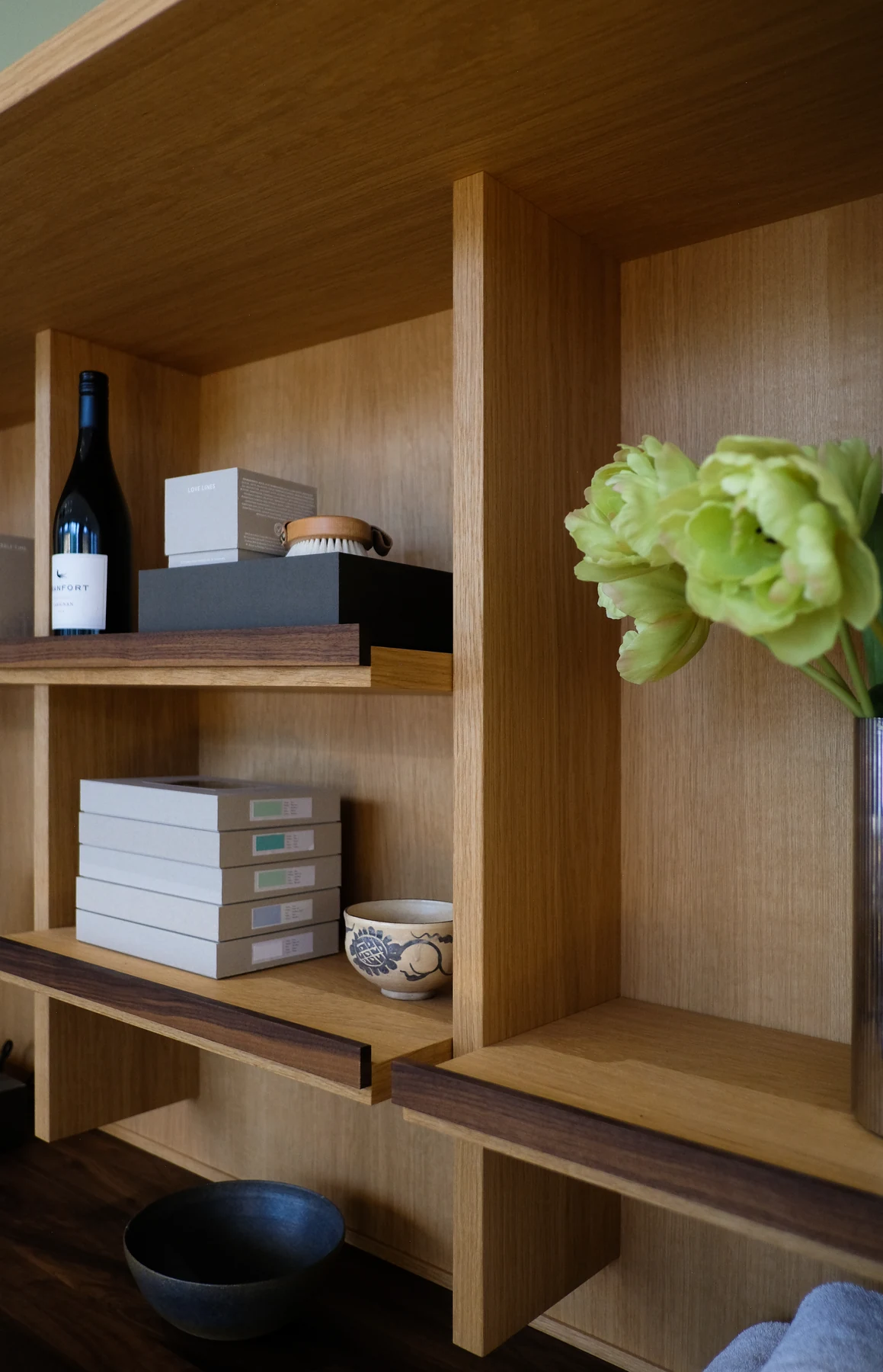 Detail of the display shelving with wine, packaged goods and fresh flowers