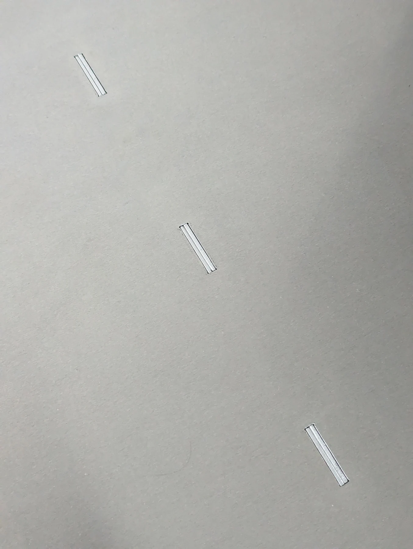 The laser-cut slots in the tabletop that lock the three elements together