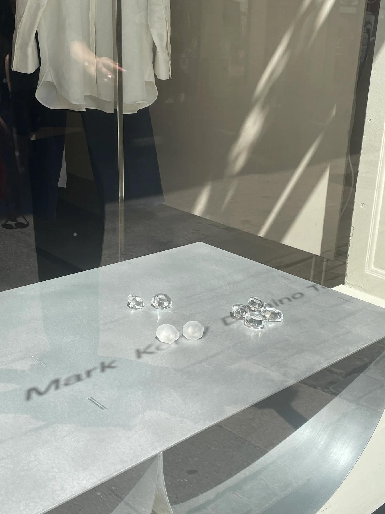 The brushed tabletop mirroring the shopfront signage above it